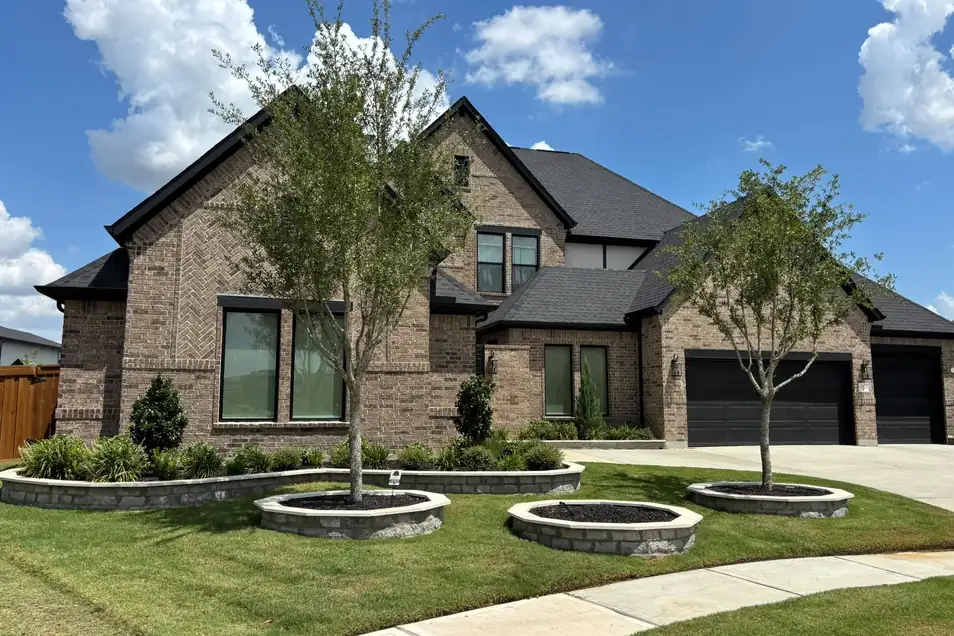 Young trees planted in front of a new home in Cypress, TX